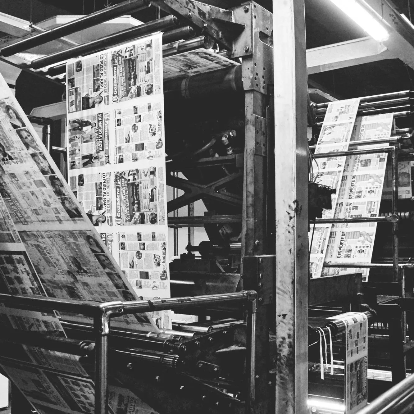 Large printing machine printing magazine pages in black and white